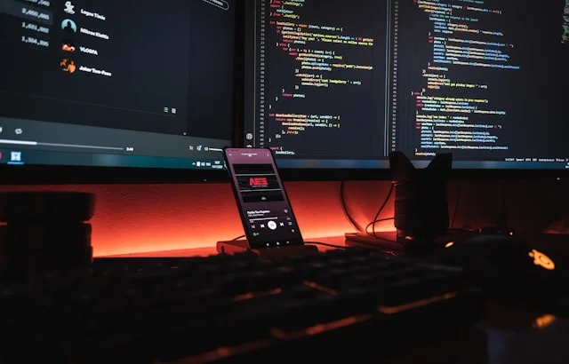close up of a professional workspace with multiple computer monitors showing clean web design layouts and source code